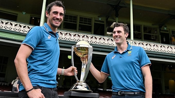 Australian cricketers Mitchell Starc (L) and Pat Cummins with 50-over World Cup trophy. - Photo: X/ @dilbag_koundal