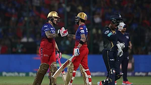 AP Photo : Royal Challengers Bengaluru's Virat Kohli congratulates captain Faf du Plessis on scoring 50 runs during the Indian Premier League cricket match between Royal Challengers Bengaluru and Gujarat Titans in Bengaluru.