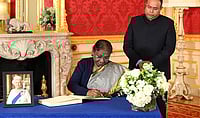WPA Pool/Getty Images : President Droupadi Murmu signing a book of condolence for Queen Elizabeth II at Lancaster House on Sep 18, 2022 in London.