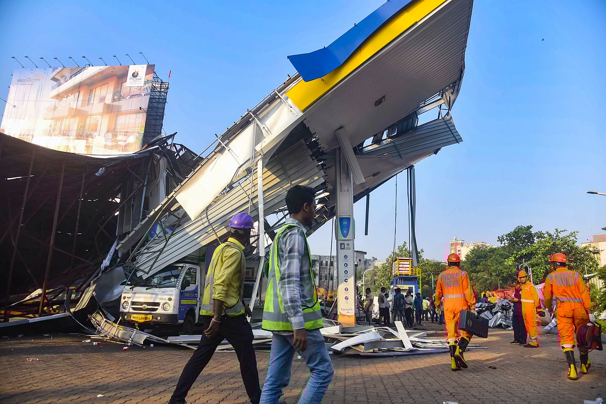 PTI : Fourteen people died as a billboard came down crashing and fell on a petrol pump due to the gusty winds in Mumbai on Monday. 
