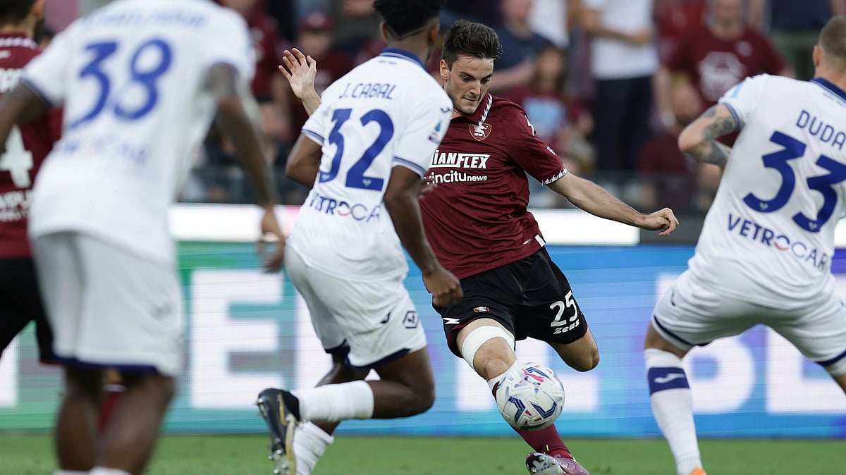 Salernitana's Giulio Maggiore, center right, and Verona's Juan Cabal battle for the ball. - AP