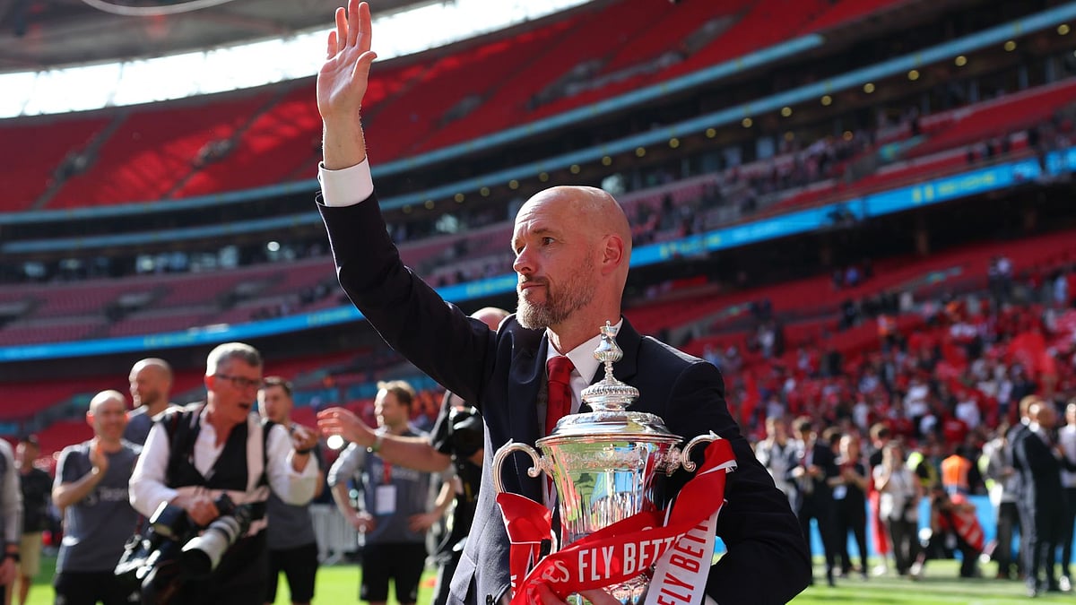Manchester United manager Erik ten Hag waves to supporters after the FA Cup title win.