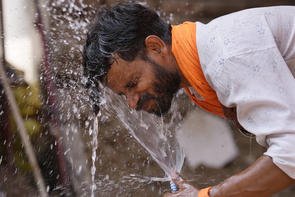 AP : Man splashes water on a hot day in Uttar Pradesh's Lucknow |