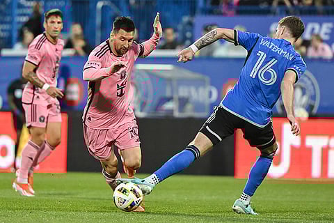 Lionel Messi fights for ball with Joel Waterman