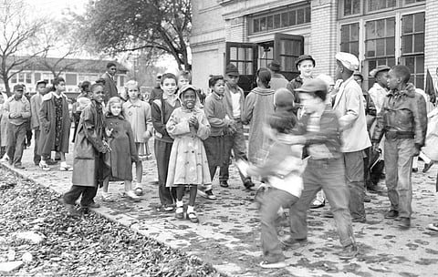 White and Black children mix freely on the playground outside a school in a racially mixed neighborhood, Oct. 18, 1957, in Detroit.