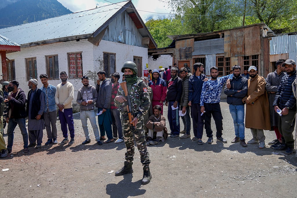 An Indian paramilitary soldier guards as Kashmiri villagers stand in a queue to cast their votes during the fourth phase of India's general election in Gund, northeast of Srinagar, Indian controlled Kashmir, Monday, May 13, 2024. - AP/Dar Yasin