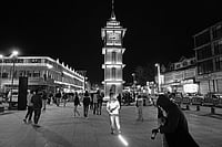 Beneath The Anger: Kashmir Now And Then Photo: Manpreet Romana : Changing Times: A tourist takes images in front of the clock tower in Lal Chowk