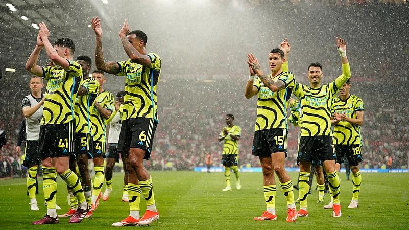 Arsenal players celebrating after winning EPL match against Manchester United. AP Photo