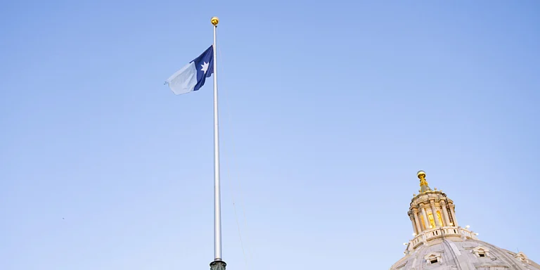 Minnesota’s new state flag features a dark blue shape resembling the state with an eight-pointed North Star. - AP