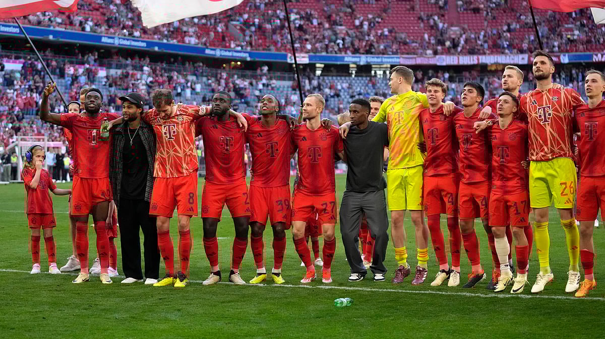 Bayern Munich players celebrate their victory at the German Bundesliga football match between Bayern Munich and VfL Wolfsburg at the Allianz Arena in Munich, Germany. - AP Photo/Matthias Schrader