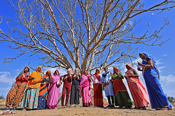 Vishal Bhatnagar/NurPhoto via Getty Images : Women are showing their fingers marked with indelible ink after casting their votes in the first phase of the Lok Sabha elections in Barwada Village, Jaipur, Rajasthan, India, on April 19, 2024.