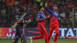 AP Photo : Royal Challengers Bengaluru's Mohammed Siraj, center, and Maxwell celebrates the dismissal of Gujarat Titans' Wriddhiman Saha, left, during the Indian Premier League cricket match between Royal Challengers Bengaluru and Gujarat Titans in Bengaluru, India, Saturday, May 4, 2024.