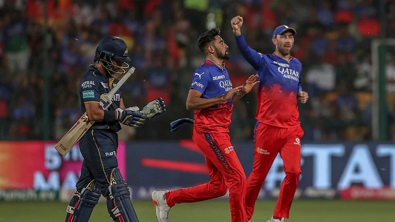 Royal Challengers Bengaluru's Mohammed Siraj, center, and Maxwell celebrates the dismissal of Gujarat Titans' Wriddhiman Saha, left, during the Indian Premier League cricket match between Royal Challengers Bengaluru and Gujarat Titans in Bengaluru, India, Saturday, May 4, 2024. - AP Photo