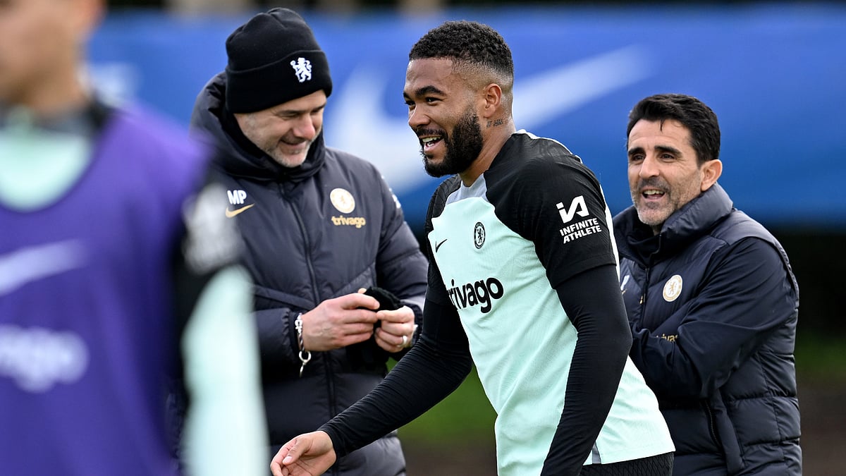 Reece James (r) jokes with Mauricio Pochettino.