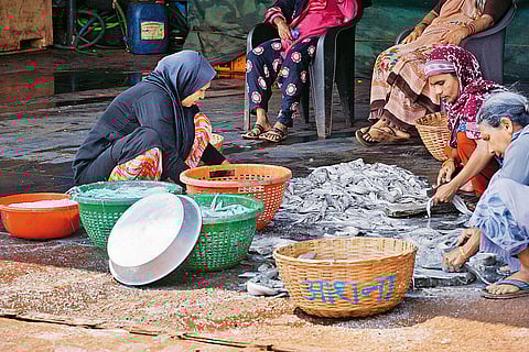Women sorting the day’s catch at the jetty