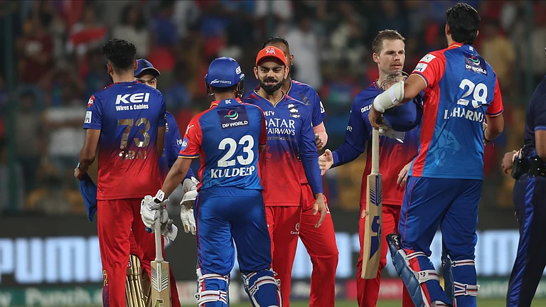 Royal Challengers Bengaluru's Virat Kohli, centre, greets Delhi Capitals players after they won the Indian Premier League cricket match against Delhi Capitals in Bengaluru. - AP Photo/Kashif Masood