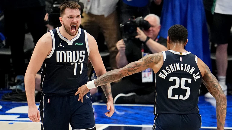 Luka Doncic and PJ Washington of the Dallas Mavericks celebrate during Game 3 of the 2024 Western Conference finals. - null