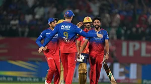 AP Photo /Ashwini Bhatia : Royal Challengers Bengaluru's Mohammed Siraj, right, celebrates the wicket of Punjab Kings' Harshal Patel, behind, wearing a helmet, during the Indian Premier League cricket match between Punjab Kings and Royal Challengers Bengaluru in Dharamsala.