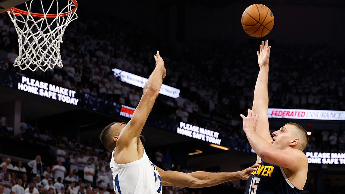 Denver Nuggets center Nikola Jokic shoots over Minnesota Timberwolves center Rudy Gobert in Game 4 of a Western Conference semifinal. - null