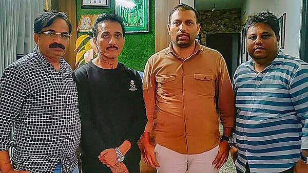 Bhavesh Bhinde in black along with Mumbai Crime Branch Personnel | - PTI