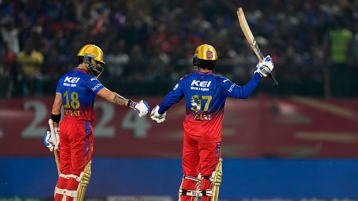 Royal Challengers Bengaluru's Rajat Patidar, right, celebrates his fifty runs as teammate Virat Kohli congratulates him during the Indian Premier League cricket match between Punjab Kings and Royal Challengers Bengaluru in Dharamsala. - AP Photo /Ashwini Bhatia