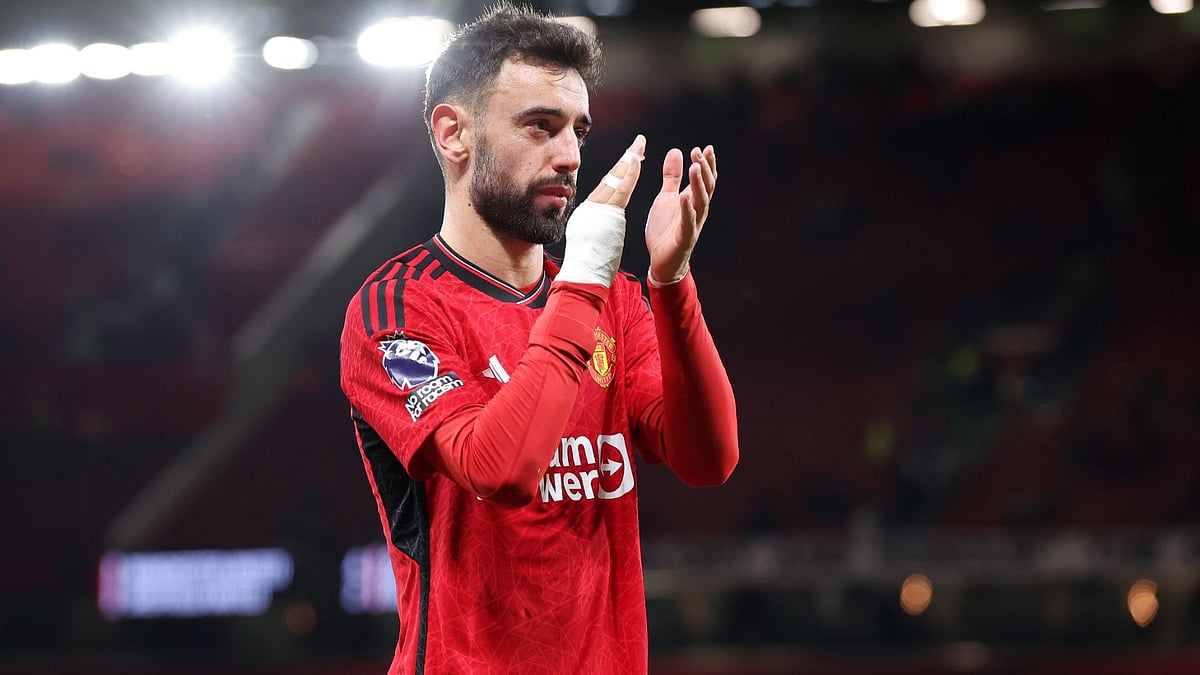 Bruno Fernandes applauds the fans at Old Trafford.