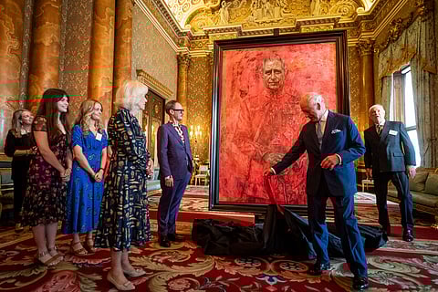 Britain's King Charles III and Queen Camilla at the unveiling of artist Jonathan Yeo's portrait of the King, in the blue drawing room at Buckingham Palace, in London, Tuesday May 14, 2024. The portrait was commissioned in 2020 to celebrate the then Prince of Wales's 50 years as a member of The Drapers' Company in 2022. The artwork depicts the King wearing the uniform of the Welsh Guards, of which he was made Regimental Colonel in 1975.