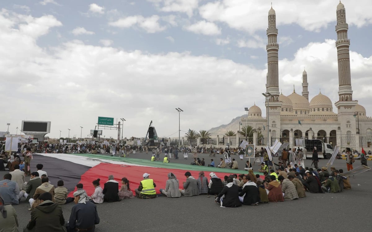 AP : Houthi supporters sit in front of a giant Palestinian flag during a rally against the U.S.-led strikes against Yemen and in support of Palestinians in the Gaza Strip, in Sanaa, Yemen, Friday, May 17, 2024 |