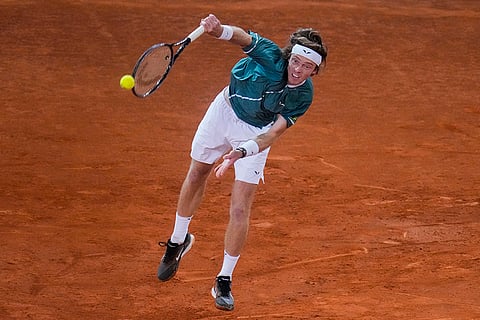 Andrey Rublev serves to Felix Auger-Aliassime