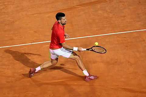 Djokovic returns the ball to Moutet