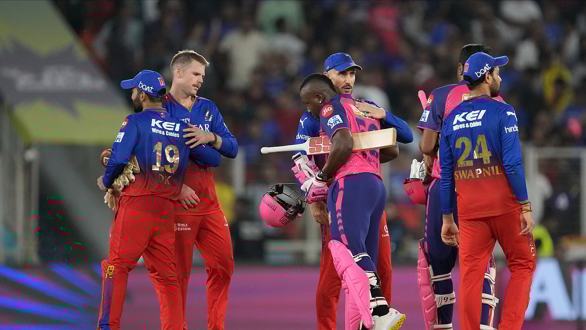 AP Photo/Ajit Solanki : Players greet each other at the end of the Indian Premier League eliminator cricket match between Royal Challengers Bengaluru and Rajasthan Royals in Ahmedabad.