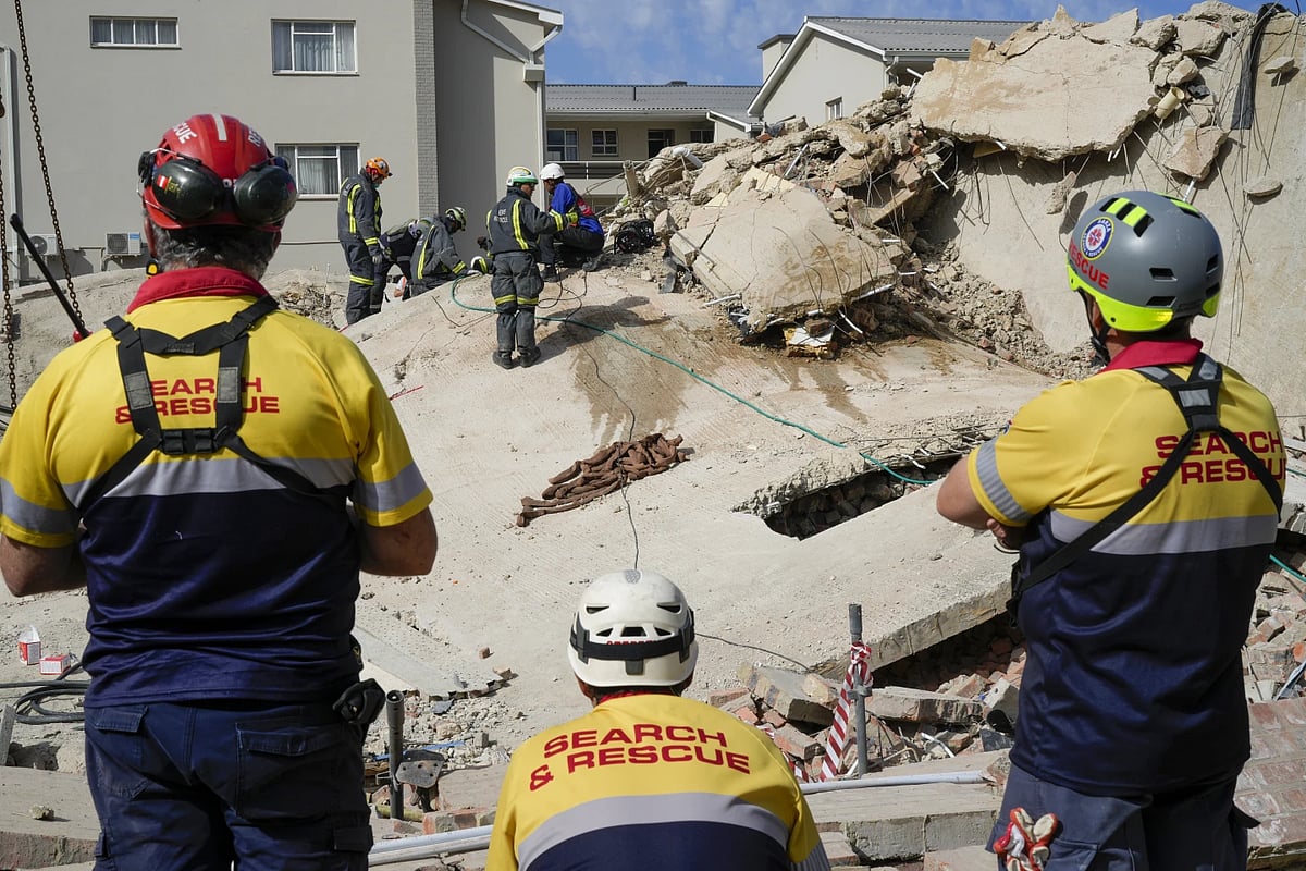AP : Rescue workers search the site of a building collapse in George, South Africa |