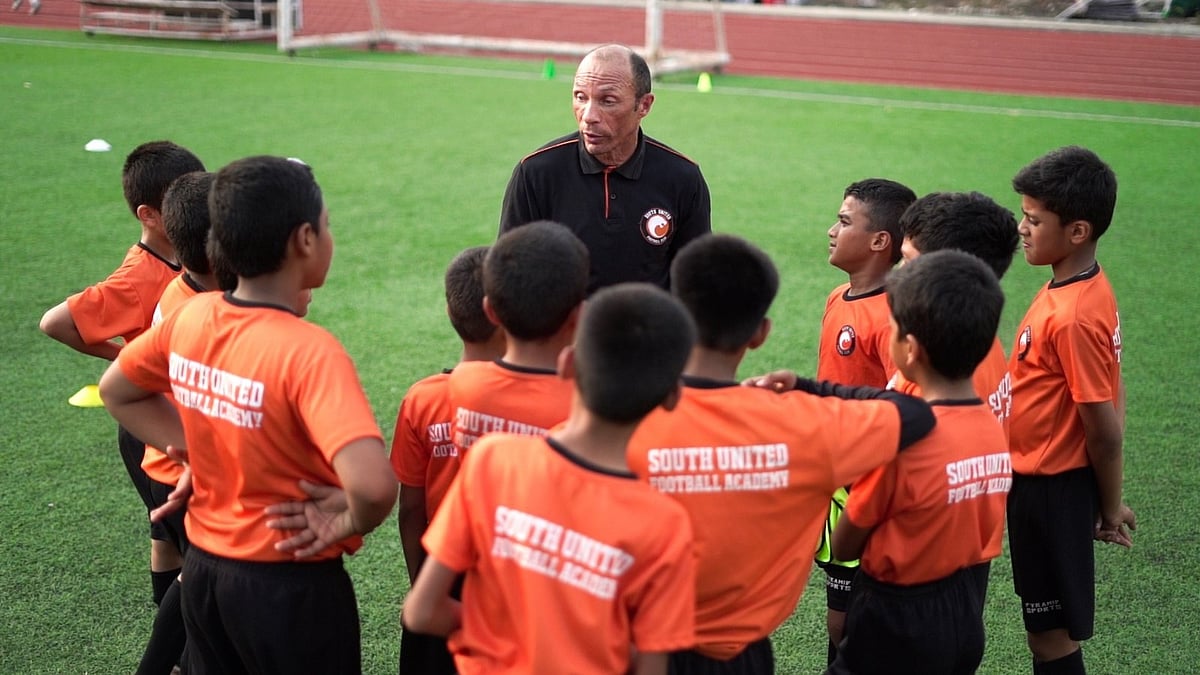 Former Chelsea and Manchester City player Terry Phelan interacting with kids in South United Football Academy. - Photo: SUFC