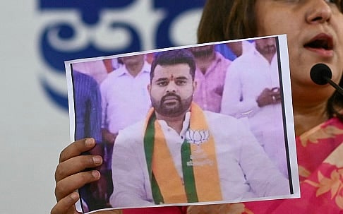 Congress spokesperson Supriya Shrinate shows a photograph featuring Prajwal Revanna at a press conference in Bengaluru on May 1, 2024 |  - Getty Images