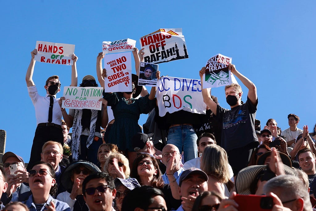 AP : Demonstrators hold up signs as a second pro-Palestine protest interrupts the UC Berkeley Law School commencement at the Greek Theater in Berkeley, Calif. Friday, May 10, 2024.
