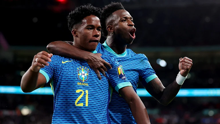 Endrick celebrates with Vinicius after scoring against England in March - null