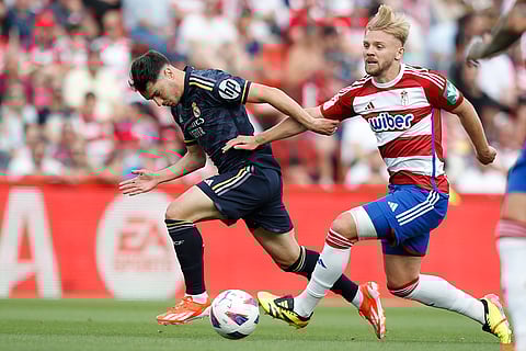 Brahim Diaz, left, and Kamil Jozwiak fight for the ball