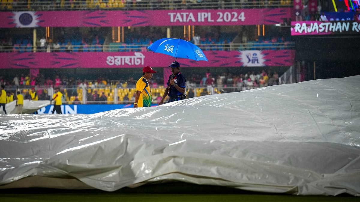 AP Photo/Anupam Nath : Officials inspect the playing field as the rain delayed the start of the Indian Premier League cricket match between Rajasthan Royals and Kolkata Knight Riders in Guwahati.