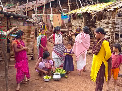 Women of Dongamati village, peeling mangoes and talking