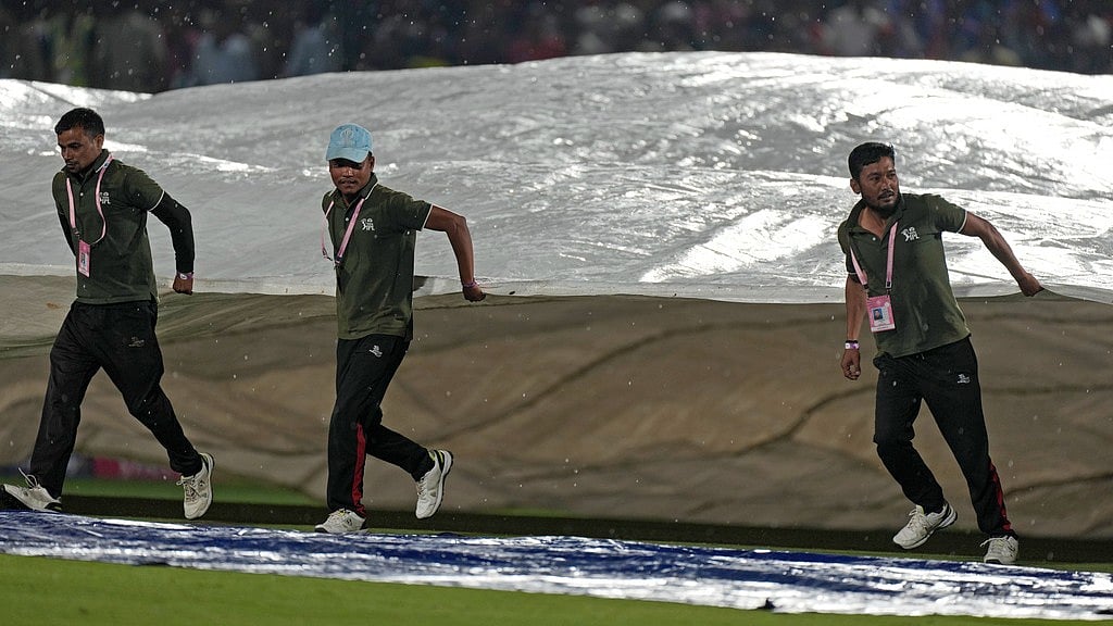 AP/Ashwini Bhatia : Covers being brought on in Dharamsala during the IPL 2024 match between Punjab Kings and Royal Challengers Bengaluru. 