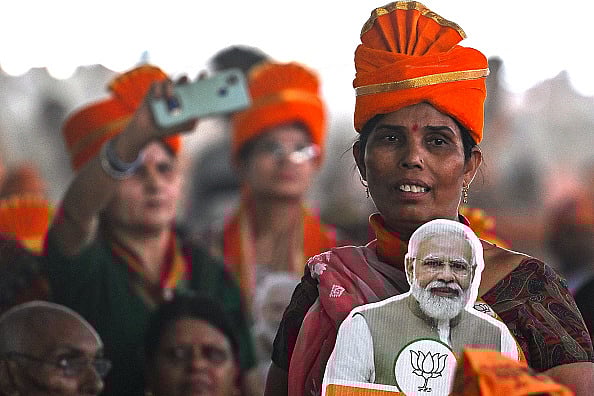Representative image/Getty Images : A woman supporter of Bharatiya Janata Party (BJP) holds a cut-out of India's Prime Minister Narendra Modi during an election campaign rally in New Delhi on May 18, 2024, ahead of the fifth phase of polling in the ongoing country's general election.