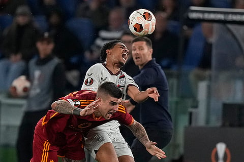 Gianluca Mancini, left, fights for the ball with Adli 