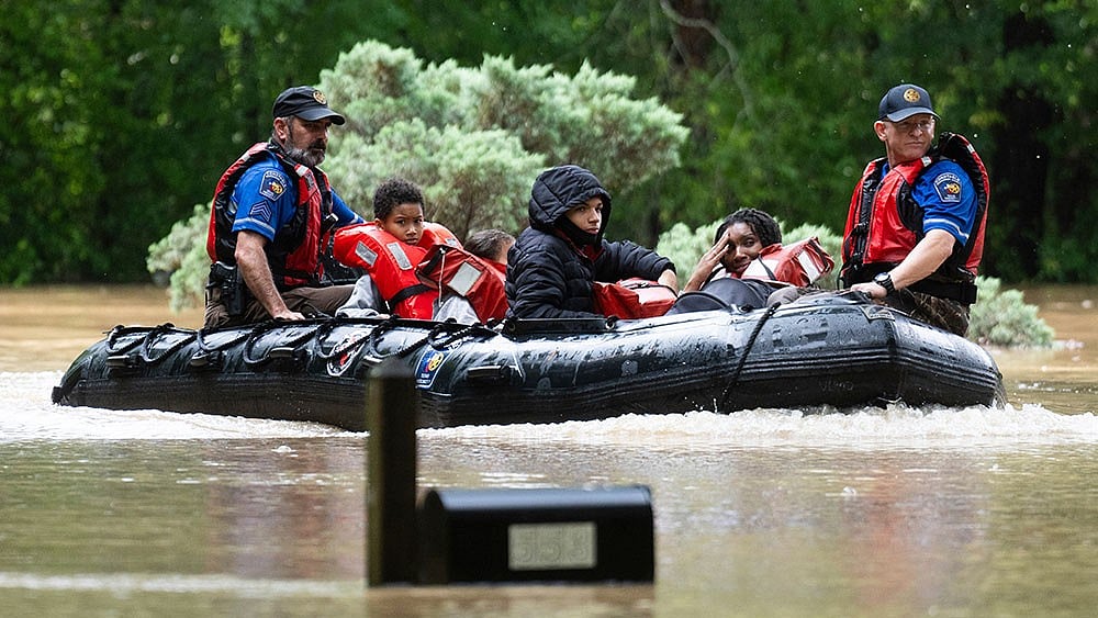 Residents being rescued by the rescue team after flood hits Texas. - AP