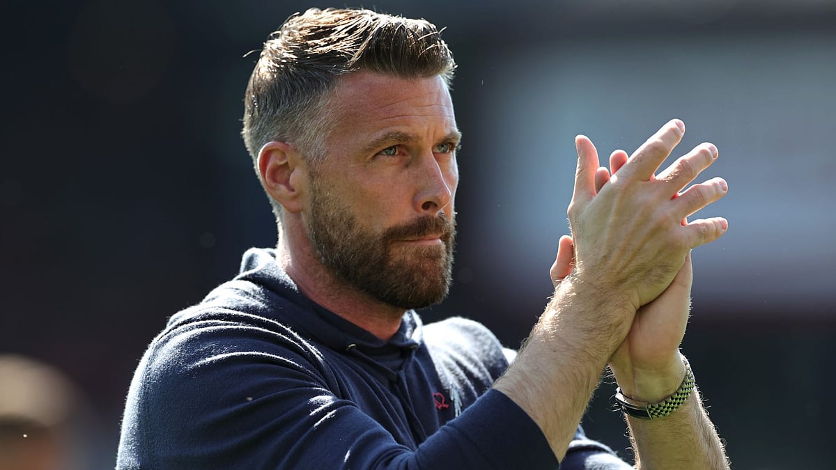 Rob Edwards applauds Luton's fans.