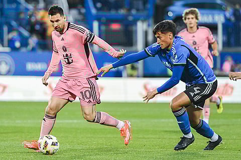 Lionel Messi duels with Fernando Alvarez