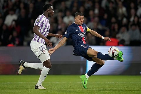 Kylian Mbappe challenged by Toulouse's Kevin Keben