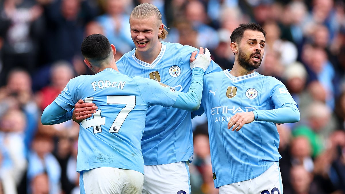 Erling Haaland (centre) celebrates with Phil Foden and Bernardo Silva