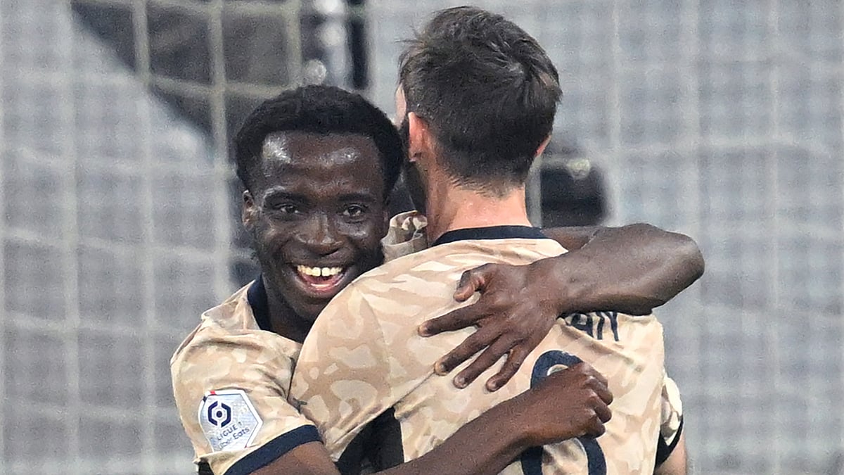 Yoram Zague embraces Fabian Ruiz after scoring his goal.
