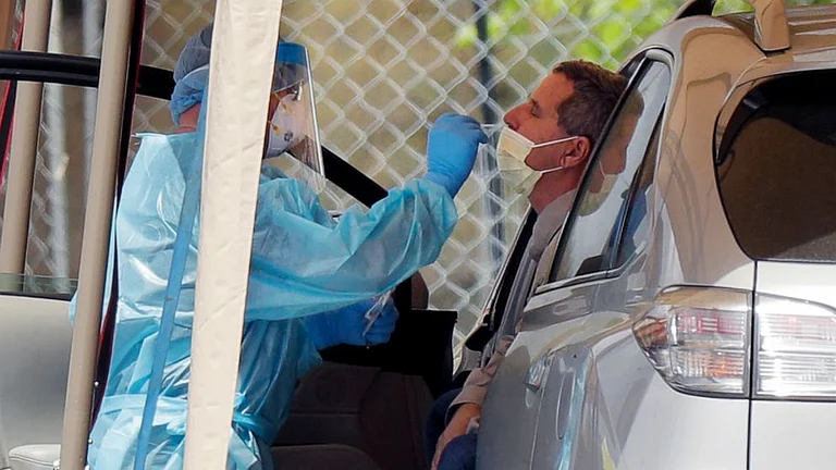 A medico conducts a test of a patient during Covid-19 pandemic.(Representational image) | - AP
