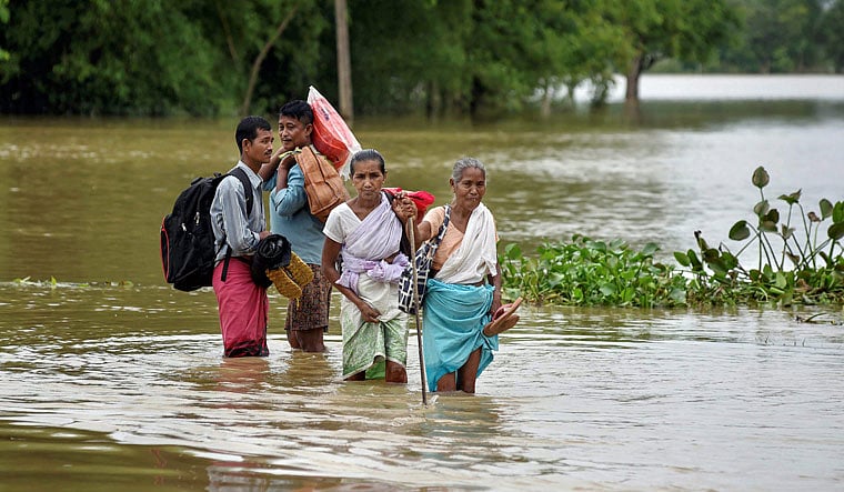 PTI : People wading through water as flood situation worsens in Assam |